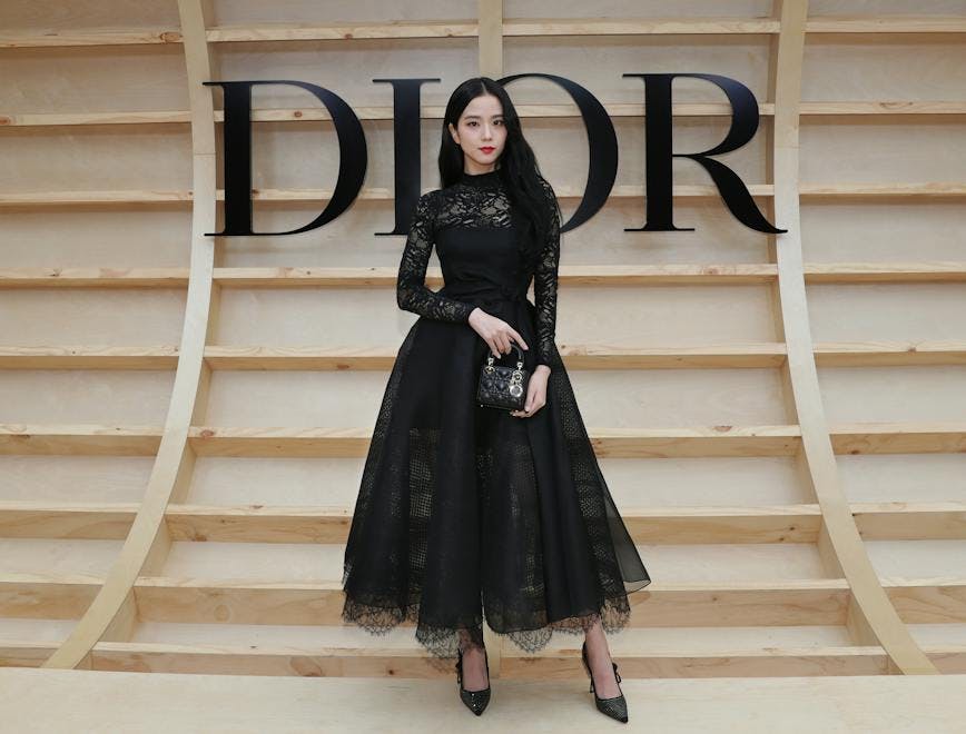 Global ambassador for Dior Fashion and Beauty, Jisoo, complemented her Dior Winter 2022/23 black embroidered dress with a black lace top with a mini Lady Dior bag and Dior shoes.