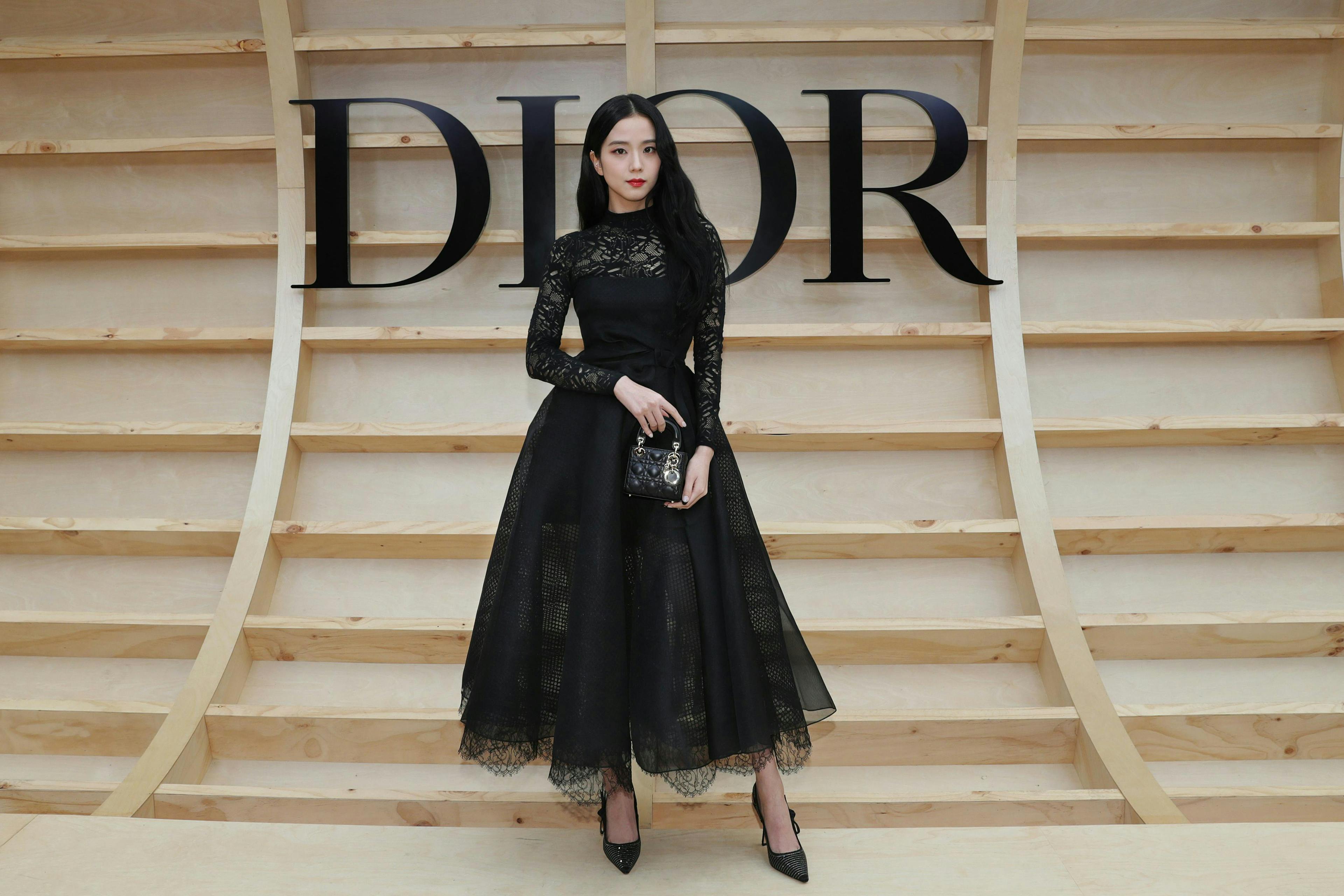 Global ambassador for Dior Fashion and Beauty, Jisoo, complemented her Dior Winter 2022/23 black embroidered dress with a black lace top with a mini Lady Dior bag and Dior shoes.