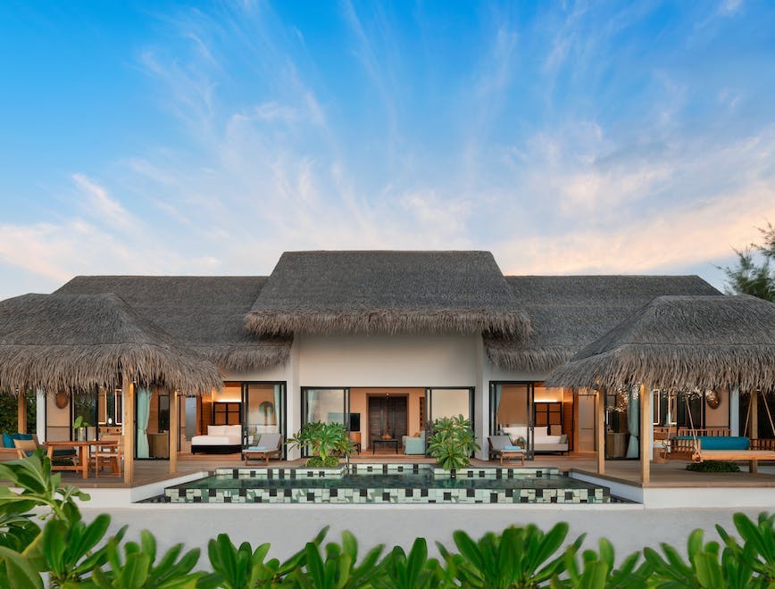hilton maldives amingiri resort and spa hilton international mleaihi - beach pool villa 2b 28570 1505504 hotel building resort villa housing desk plant chair couch outdoors